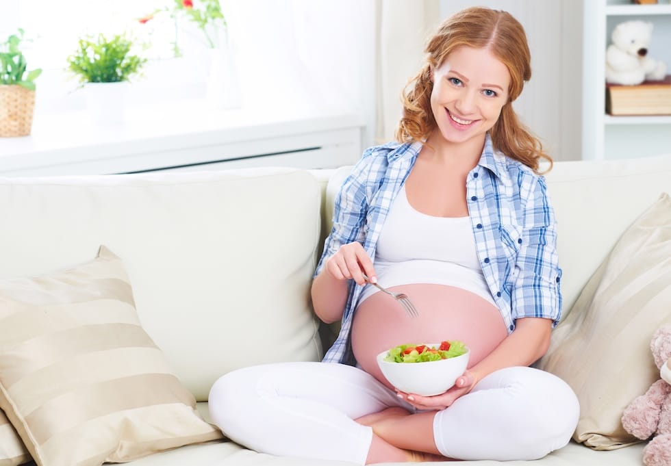 Future mother eating salad