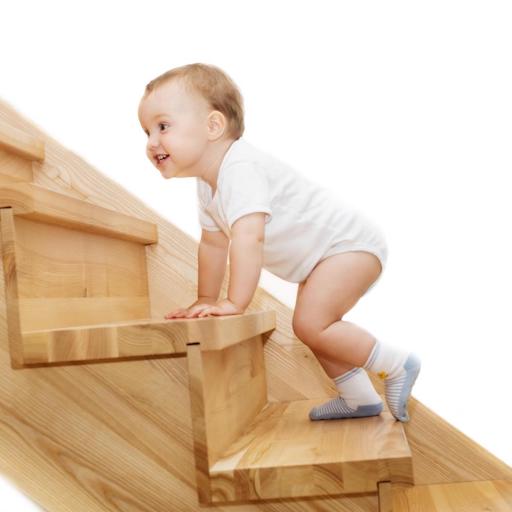 Baby wearing bodysuit climbs stairs