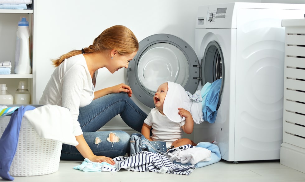 Mother-with-baby-preparing-clothes-for-washing