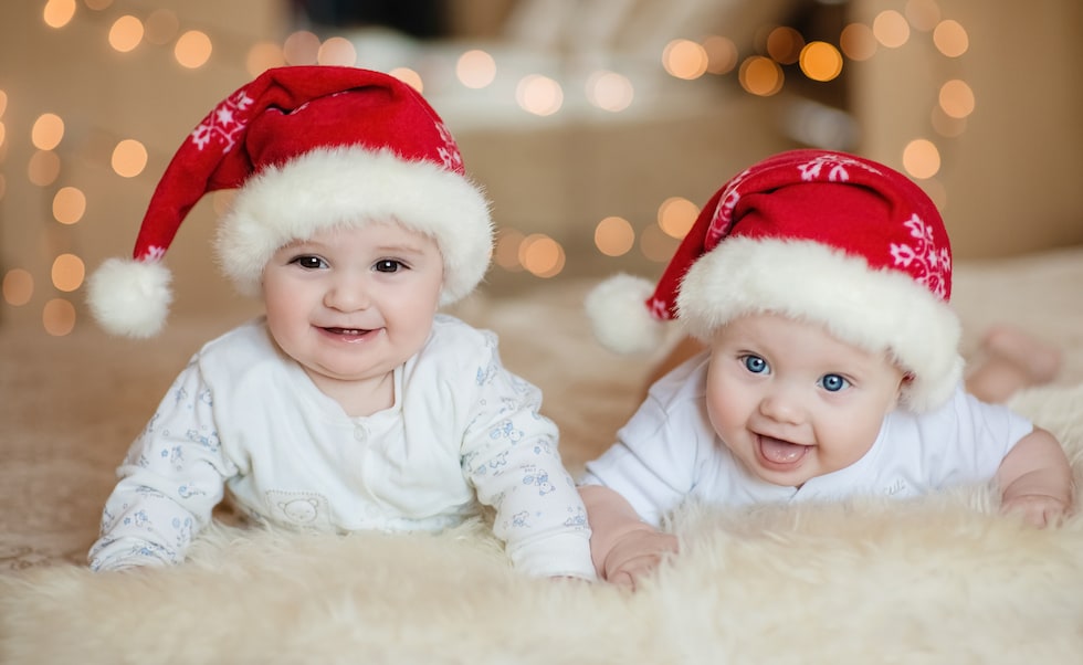 Babies wearing Christmas clothes