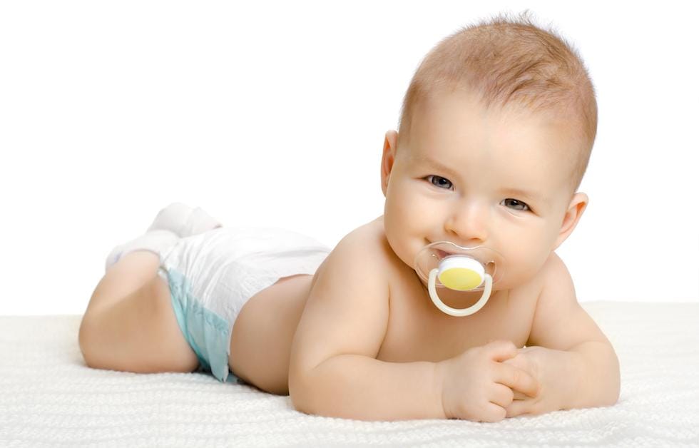 Baby with pacifiers in the mouth